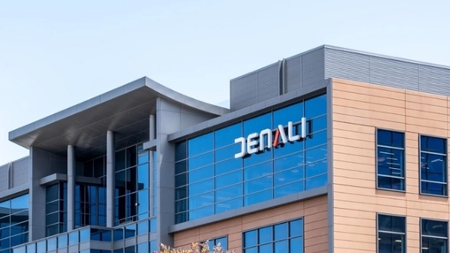 Denali Therapeutics headquarters with the company name on a glass-fronted building under a clear blue sky